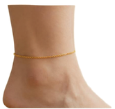 Steala permanent jewelry postcard - Steala LLC Fine Art Accessories Close-up of a bare ankle wearing a thin gold chain anklet on the left leg, against a white background.